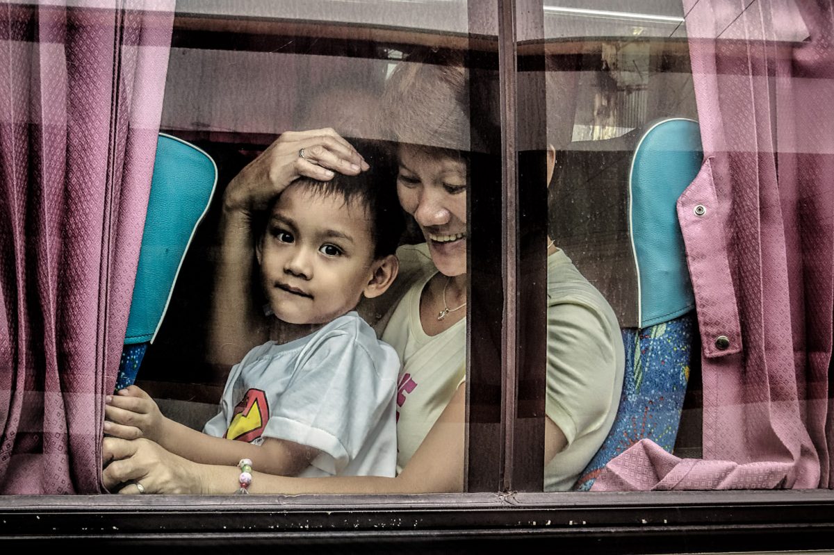 Mother and son share a seat on the Manila to Bulacan bus.  It's common for a child to sit on their parent's lap to make room for more passengers.